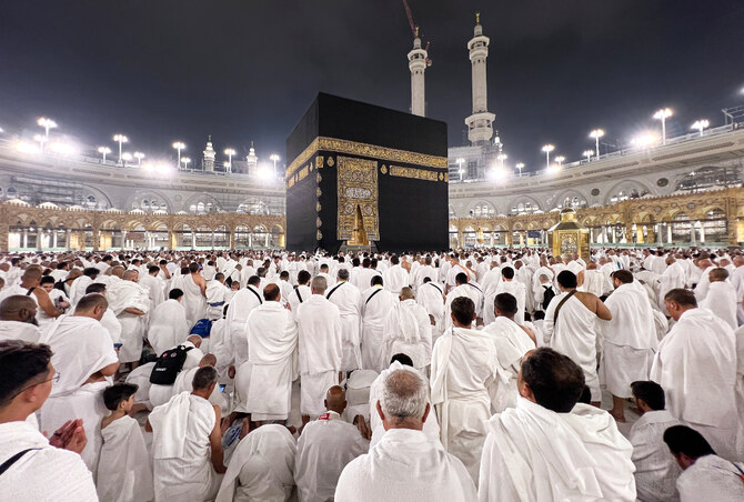 Pilgrim wearing Ihram clothing at Miqat station preparing to make intention for Umrah before entering the sacred state of Ihram