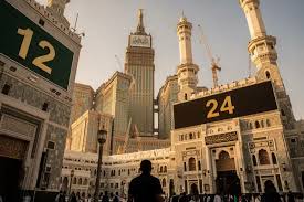 Pilgrim checking Google Maps on smartphone near Masjid al-Haram in Makkah trying to find hotel location during Umrah journey