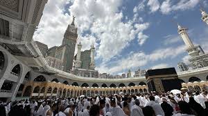 Pilgrims standing in Masjid al-Haram in Makkah facing the Kaaba during Umrah, showing calm and reflective emotions on first sight