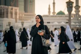 Stressed pilgrim checking empty pocket near Masjid al-Haram in Makkah after losing mobile phone during Umrah journey